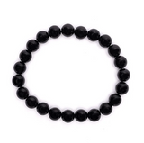 Bracelet bouclier d'énergie en tourmaline noire: perles rondes noir profond alignées en chaîne élastique.