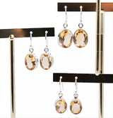 Boucles d'Oreilles Éclat Solaire Citrine et Argent 925, pendantes ovales citrines argentées brillantes sur crochets.