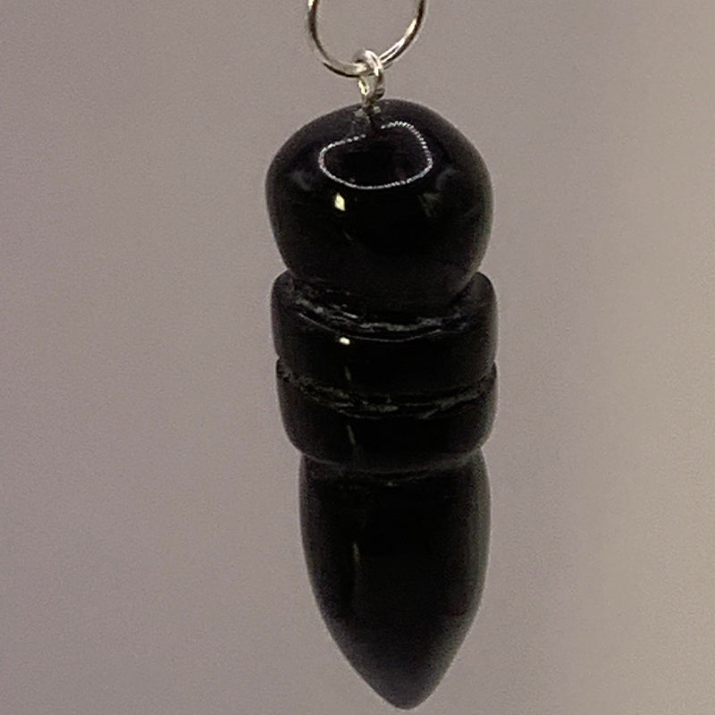 Pendule egyptien en onyx noir, sculpté en forme de pointe, suspendue par un anneau métallique.